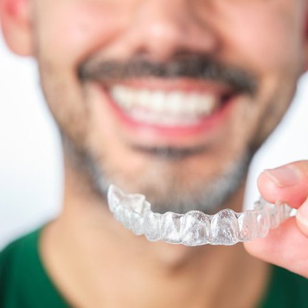 a man holding onto Angel Aligners