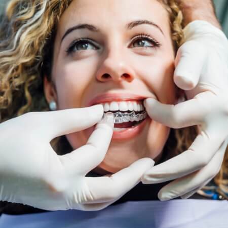 Woman receiving Invisalign clear braces treatment