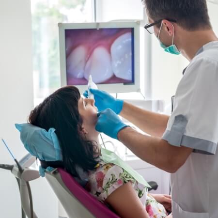 Dentist using intraoral camera to capture smile photos