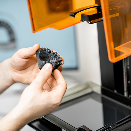 Dentist using a sprint ray 3 D printer