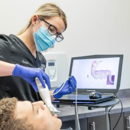 Dental team member using digital impression system