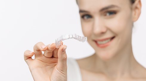 a patient holding their clear aligner