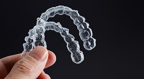 a close-up of two clear aligners