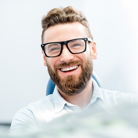 man smiling while in treatment chair