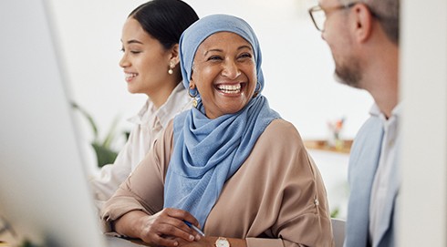 Woman smiling at coworker in office