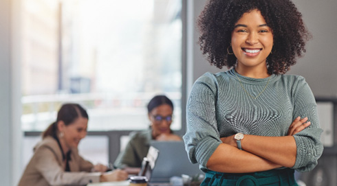 Woman smiling in conference room with colleagues