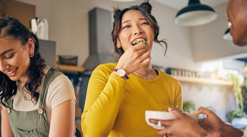Group of friends enjoying meal together in kitchen