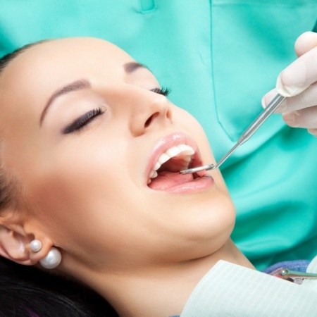 Dental patient receiving preventive dentistry checkup and teeth cleaning