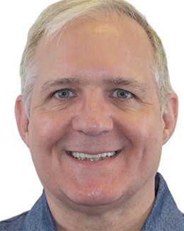 Dentist showing dentistry patient dental implant model