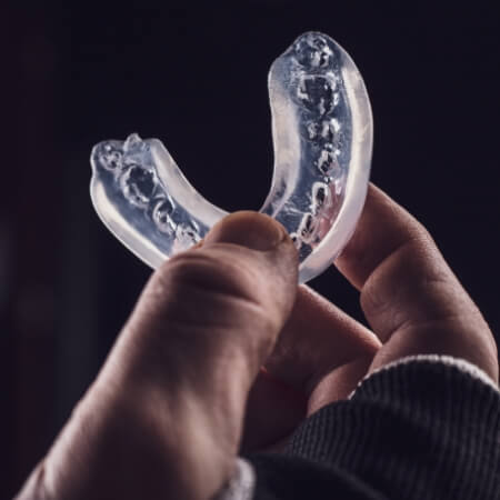 Hand holding an occlusal splint