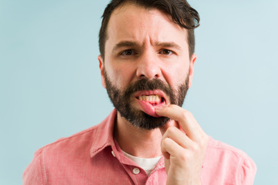 man pointing to inflamed gums