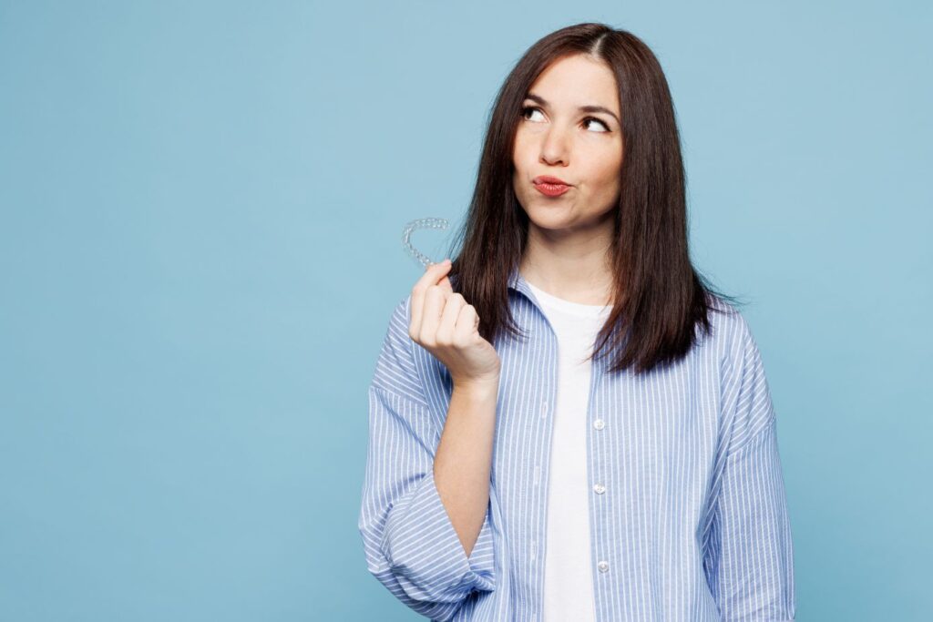 A woman holding an Angel Aligner