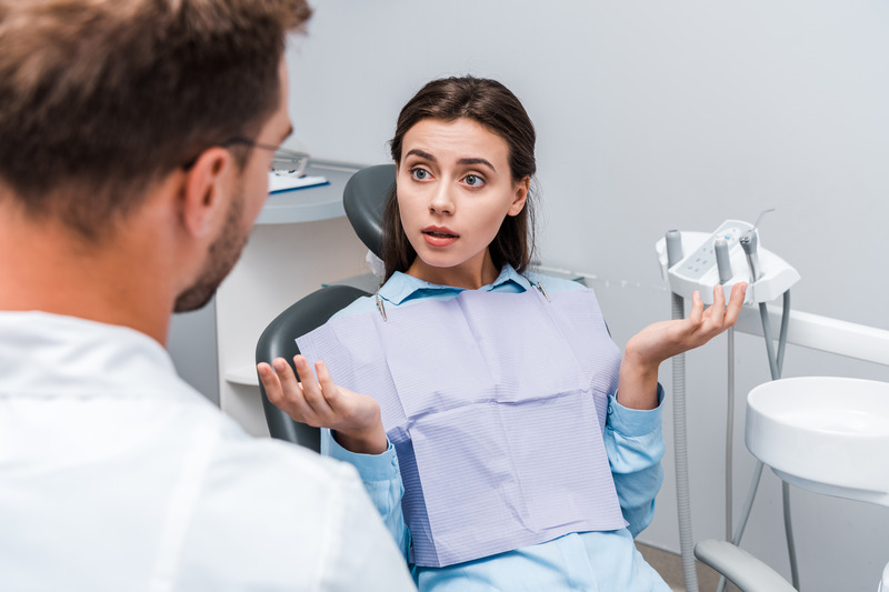 Patient talking to dentist about dental implant failure